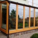 Opravená okna zimní zahrady za pomoci hliníkového opláštění s dekorem dřeva